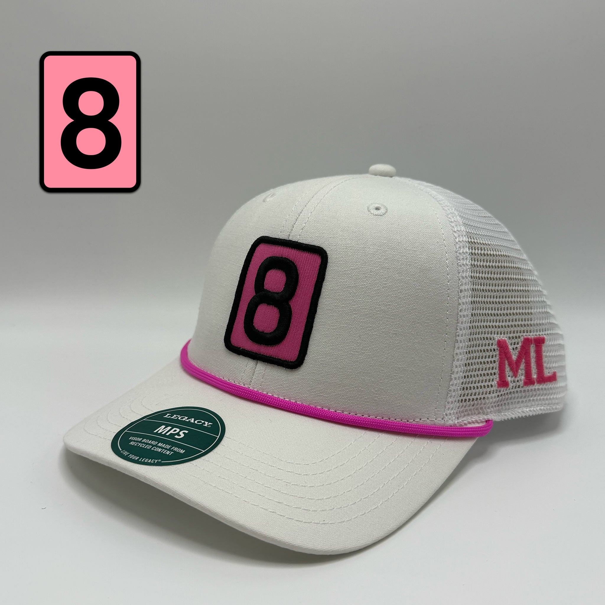 A white trucker-style baseball cap with a pink and black embroidered number 8 patch on the front, a pink brim stripe, and pink 'ML' lettering on the side mesh. A pink square with a black number 8 is shown in the upper left corner.